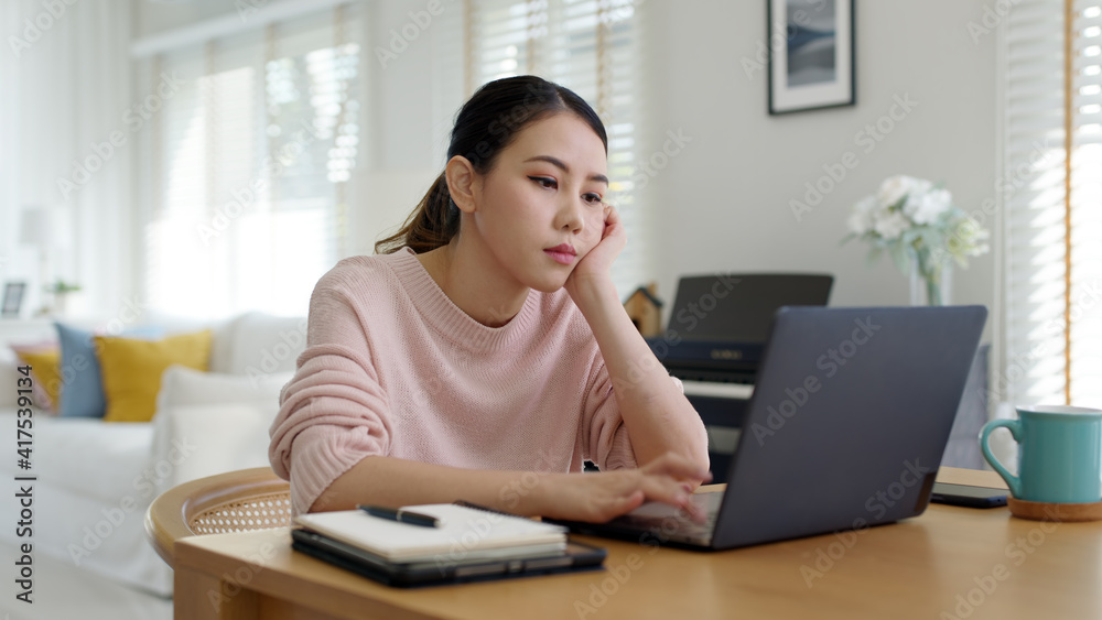 Back rear view young asian woman employee work from home using computer notebook videocall meeting conference angry annoy with low poor unreliable internet wifi connection problem issue outage. Back rear view young asian woman employee work from home using computer notebook videocall meeting conference angry annoy with low poor unreliable internet wifi connection problem issue outage.