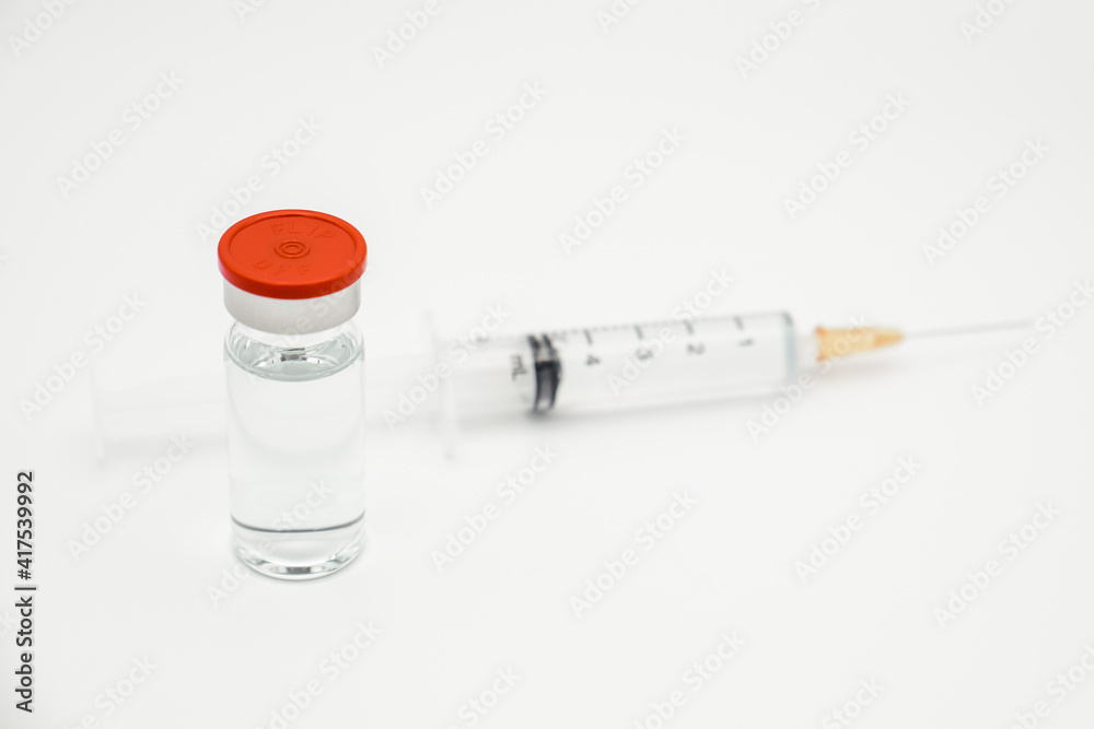 Vaccine bottle dose with drug needle syringe on white background. Injection treatment flu disease care hospital prevention virus. Immunity chemistry research in the lab. Covid-19, Coronavirus concept. Vaccine bottle dose with drug needle syringe on white background. Injection treatment flu disease care hospital prevention virus. Immunity chemistry research in the lab. Covid-19, Coronavirus concept.