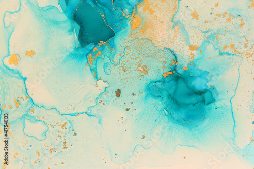art photography of abstract fluid art painting with alcohol ink, blue and gold colors © tomertu