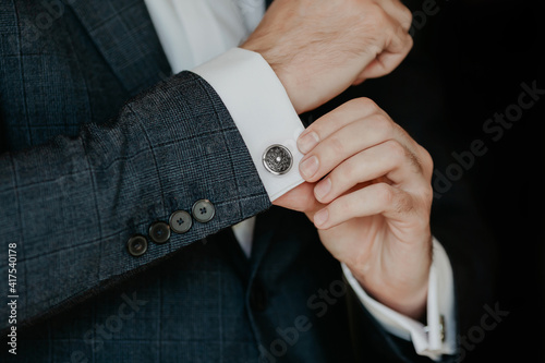 Quadro su tela Close-up of a man in a tux fixing his cufflink.