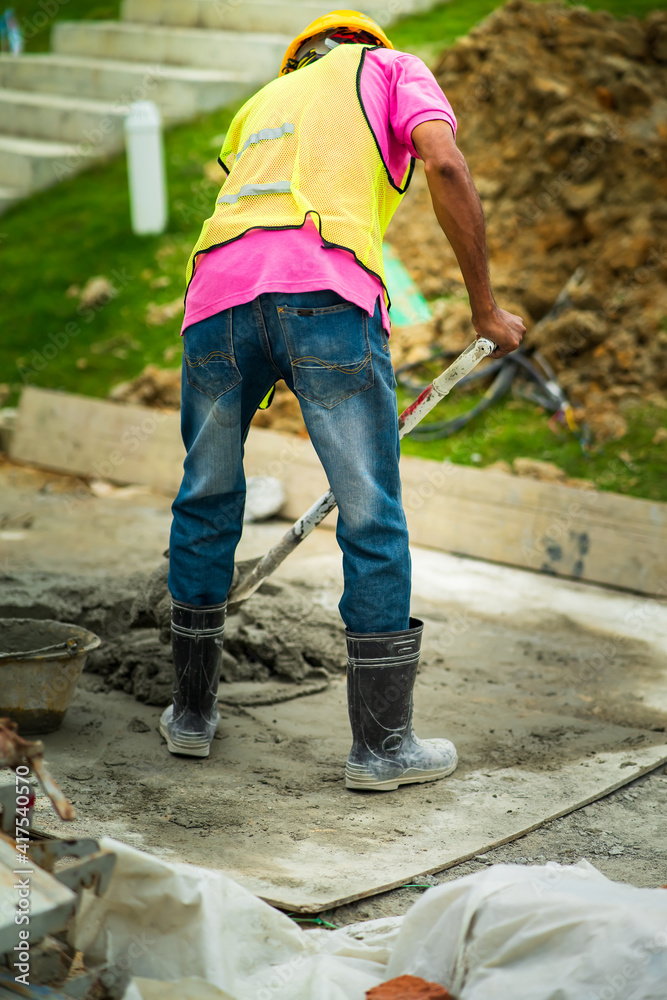 view from behind of construction worker in the construction site. view from behind of construction worker in the construction site.