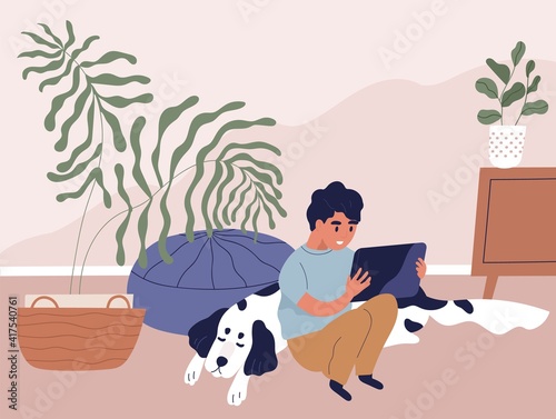 Boy using tablet PC and surfing internet at home. Happy kid sitting on floor in room, holding gadget, looking at screen and playing online games. Colored flat vector illustration