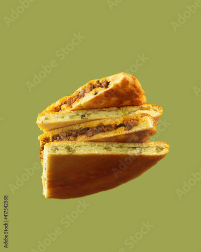 Traditional Ossetian pie with meat and suluguni cheese. Bottom view. Creative still life. Low carb keto baked goods made with almond, coconut flour and protein isolate.