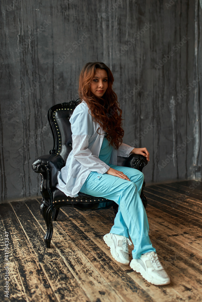 Beautiful nurse with books in the library. Nurse, student, education.