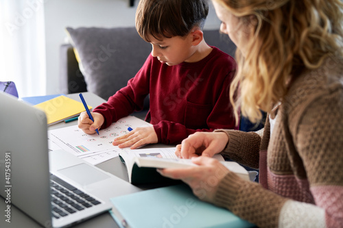 Photos Mother helping her son with schoolwork