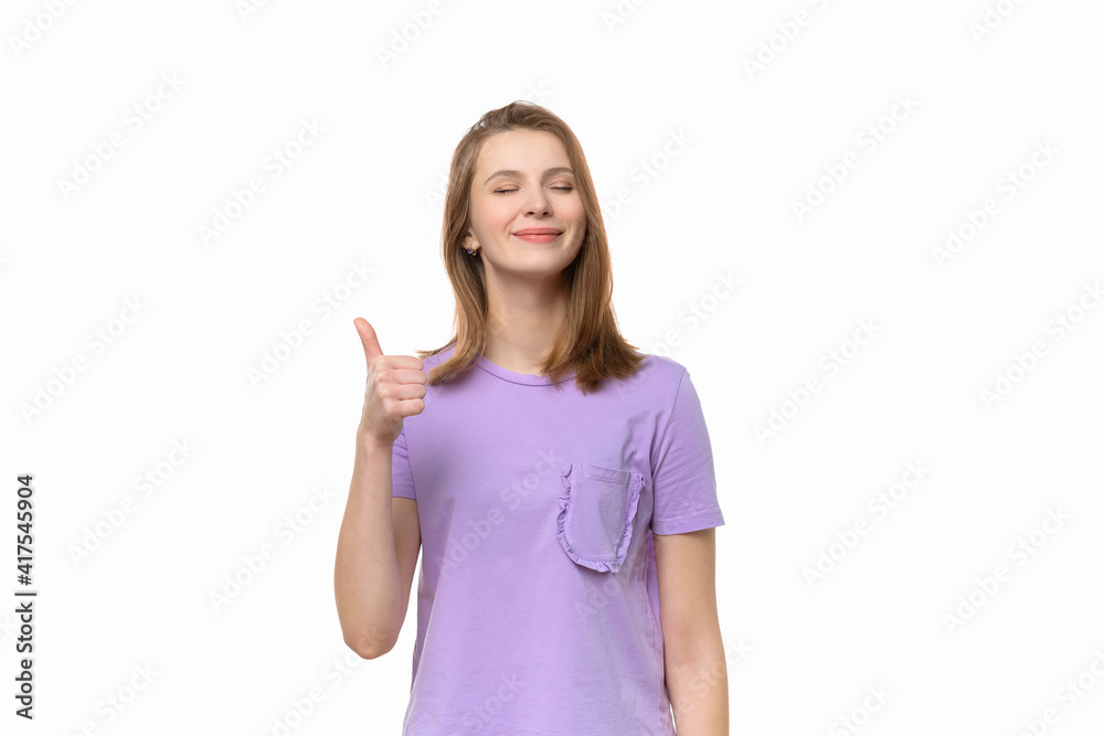 Beautiful young woman wearing casual tshirt showing thumb up gesture and smiling Beautiful young woman wearing casual tshirt showing thumb up gesture and smiling
