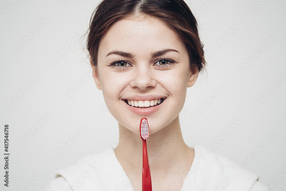 cheap woman in white robe toothbrush hygiene in the morning close-up cheap woman in white robe toothbrush hygiene in the morning close-up