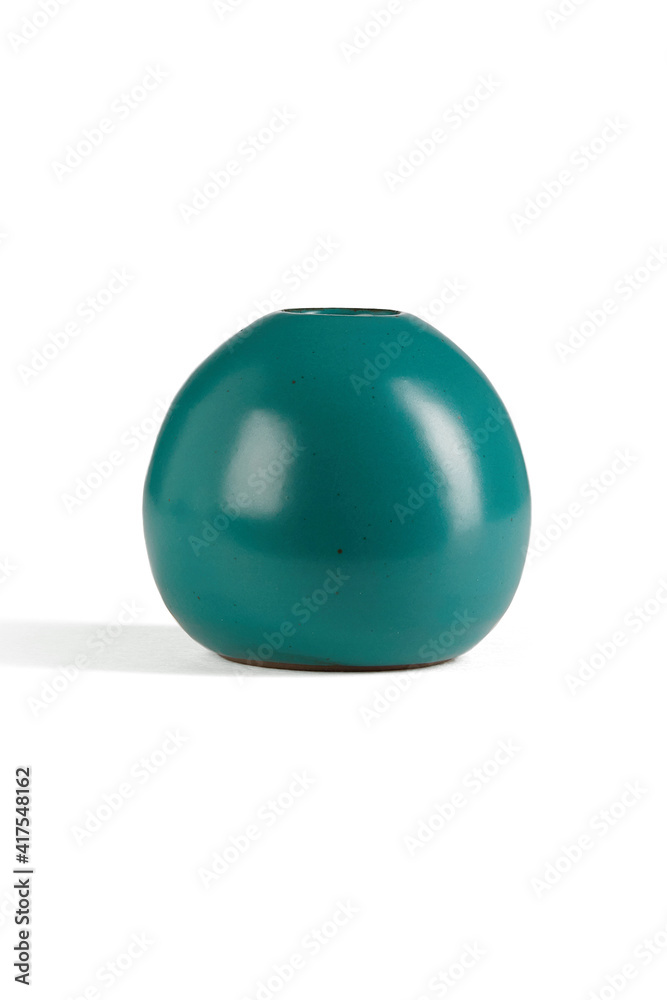 Subject shot of emerald green ceramic vase with glazed surface. The spherical Scandinavian bowl with narrow neck is isolated on the white background. Subject shot of emerald green ceramic vase with glazed surface. The spherical Scandinavian bowl with narrow neck is isolated on the white background.