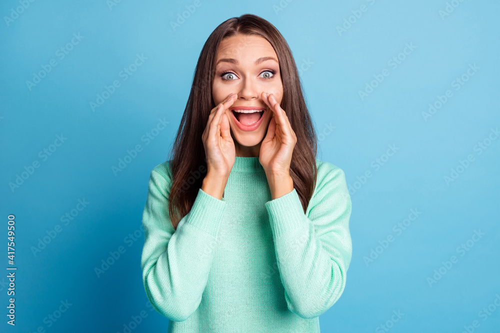 Photo portrait of woman announcing with two hands touching face isolated on pastel blue colored background Photo portrait of woman announcing with two hands touching face isolated on pastel blue colored background