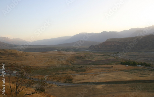 Mountain road. White peaks. Dangerous cliffs. Pamir. Fast river. Rocks. Dangerous road. Roof of the world. Talikistan. Badakhshan.Traveling in the mountains. Afganistan. Murgab.