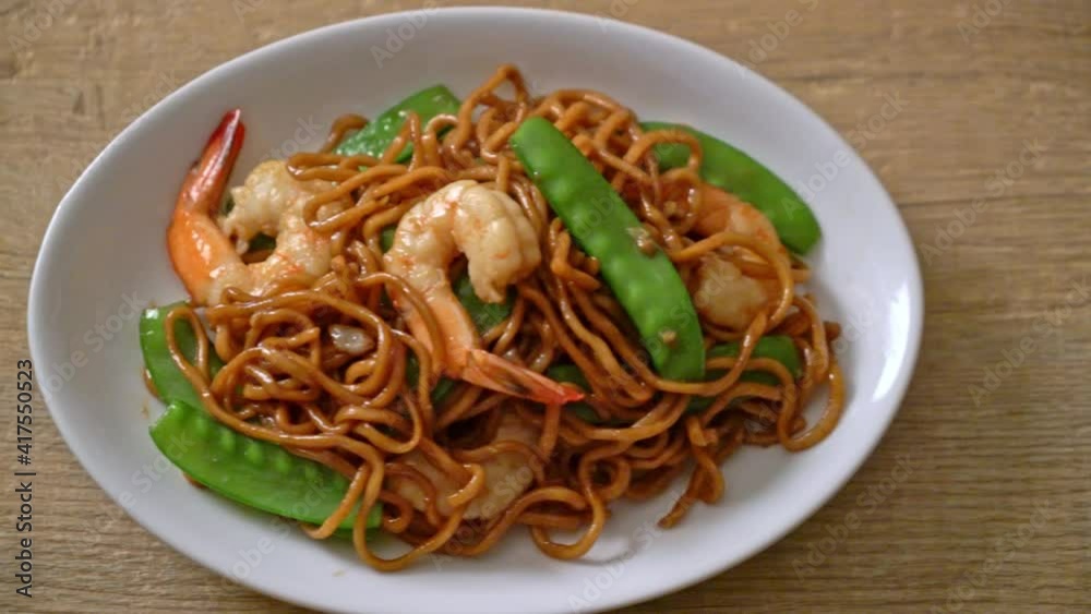 stir-fried yakisoba noodles with green peas and shrimps - Asian food style stir-fried yakisoba noodles with green peas and shrimps - Asian food style