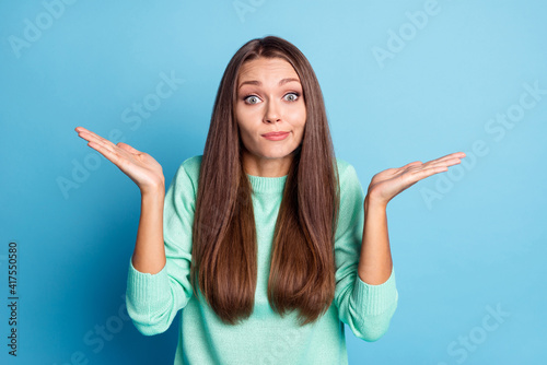 Canvas Print Portrait of lovely hesitant girlish brown-haired girl shrugging shoulders have n