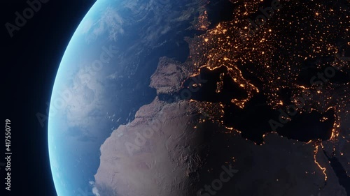 Fly over the spinning planet Earth. Day to night transition as seen from space. Glowing bright city lights shine at European continent, African continent and then North America