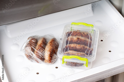 Frozen cutlets in a container in a refrigerator. Ready frozen food. Fast cooking concept. photo