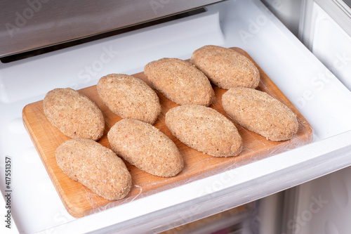 Frozen food in the refrigerator. Plastic bag with cutlets in refrigerator photo