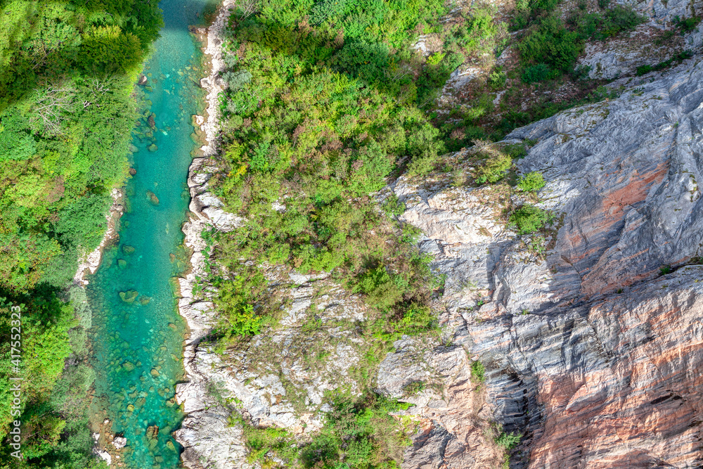 Mountain river flowing in a canyon . Drone shot . River with transparent clear water 