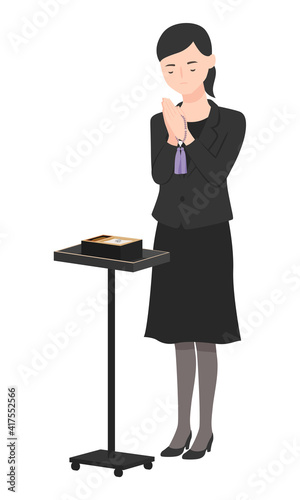 喪服の女性。焼香台の前で手を合わせて女性のイラスト。