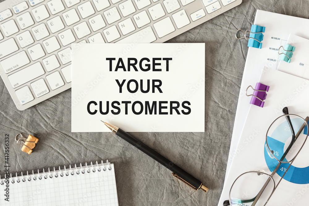 Target your Customers is written in a document on the office desk Target your Customers is written in a document on the office desk