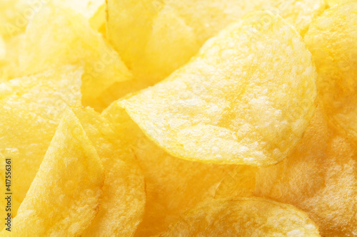Potato chips pattern. Yellow salted potato chips as food background. Chips texture  studio photo  close up