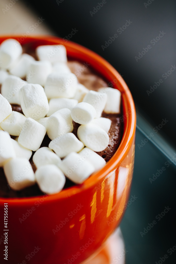 Orange cup with hot cocoa and marshmallows