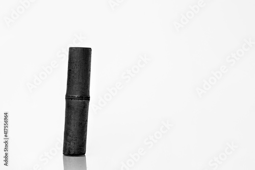 Bamboo charcoal water filter stick. Natural bamboo charcoal is a powerful purifier which refreshes tap water. Electromagnetic shielding, air filtration, and decor concept. photo