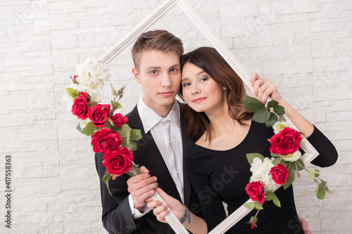 A young woman and young men in a romantic photo session, their love story.