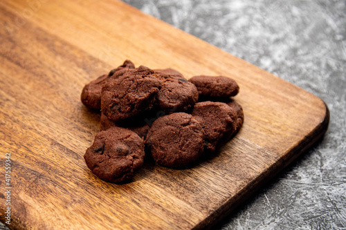 Delicious homemade chocolate cookies on a wooden plate