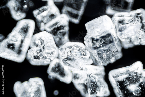 Crystal sugar close up on black background under the light microscope with a magnification of 40 times