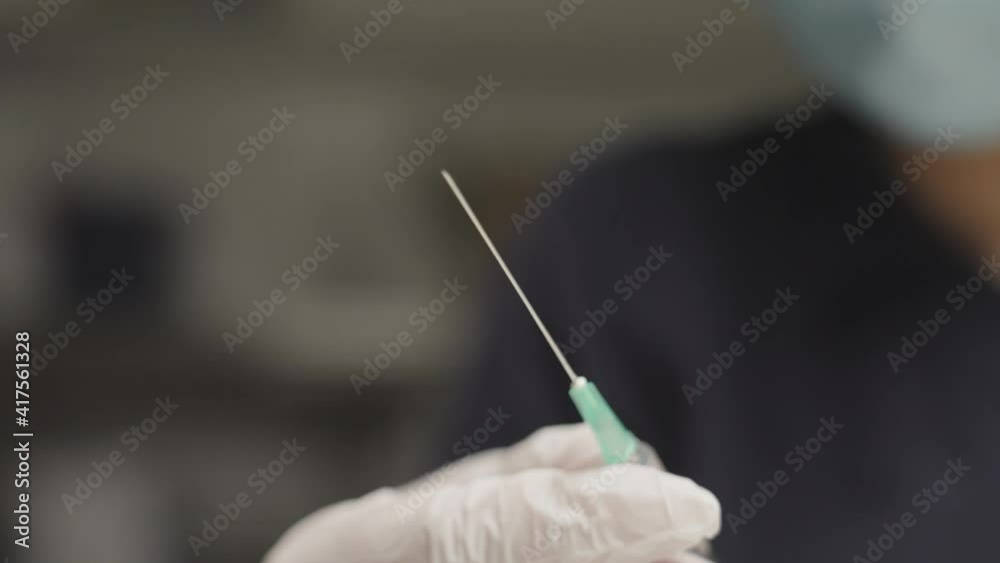 Doctor In Surgical Gloves Holding Syringe Doctor In Surgical Gloves Holding Syringe