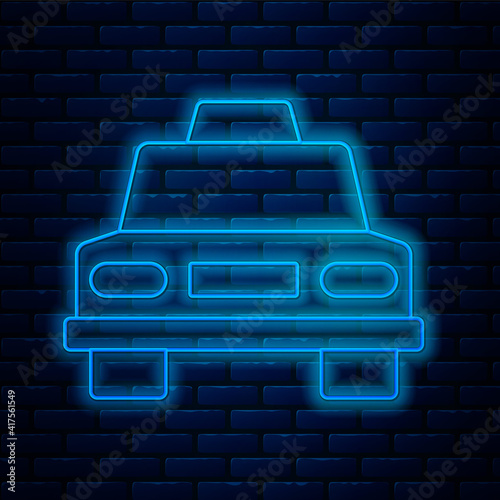 Glowing neon line Taxi car icon isolated on brick wall background. Vector.