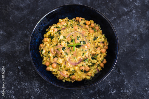 vegan chickpea potato spinach curry with almonds and onions, healthy plant-based food