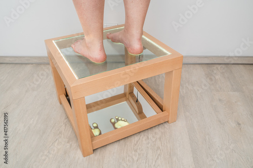 Foot examination - close up. Orthopedics, foot podoscope test. Barefoot footprint test. photo