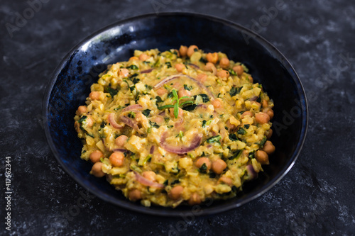 vegan chickpea potato spinach curry with almonds and onions, healthy plant-based food