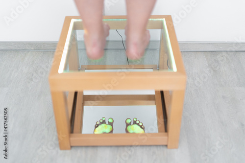 Foot examination - close up. Orthopedics, foot podoscope test. Barefoot footprint test. photo