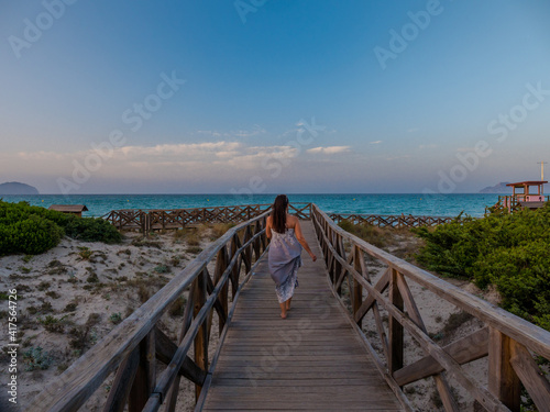 girl at sunset at the beach of alcudia en majorca,balearic islands of spain