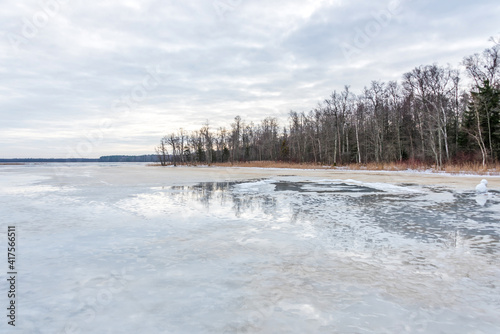 Frozen Lake in February in Latvia with Cloudscape