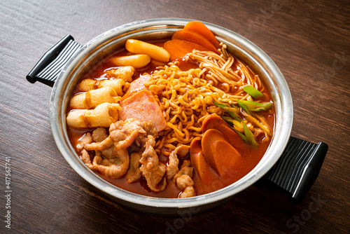 Budae Jjigae or Budaejjigae (Army stew or Army base stew). It is loaded with Kimchi, spam, sausages, ramen noodles and much more photo