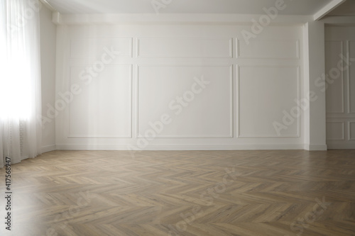 Parquet floor in light spacious empty room photo