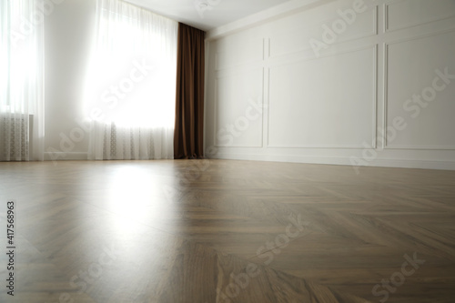 Parquet floor in light spacious empty room