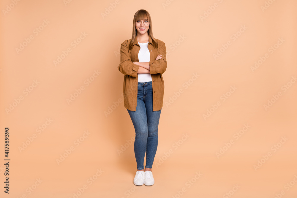 Full size photo of charming happy young woman folded hands charming smile good mood isolated on beige color background