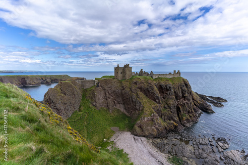 Dunnottar Castle is a ruined medieval fortress located upon a rocky headland on the northeastern coast of Scotland , Aberdeenshire , Scotland