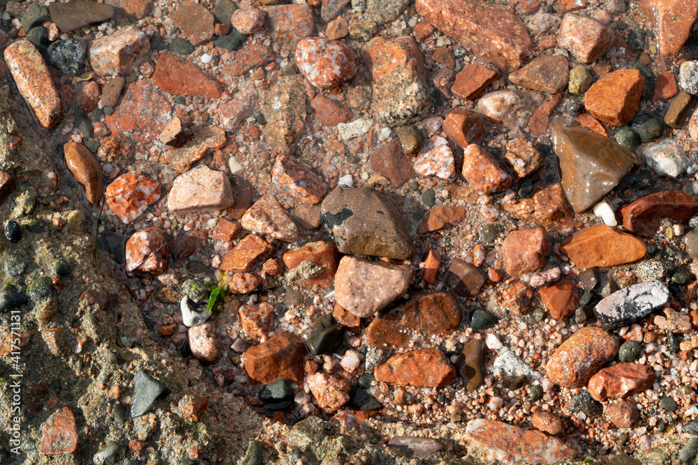 Red Sand and Stones of the red Sea Coast, Natural Texture Background Red Sand and Stones of the red Sea Coast, Natural Texture Background