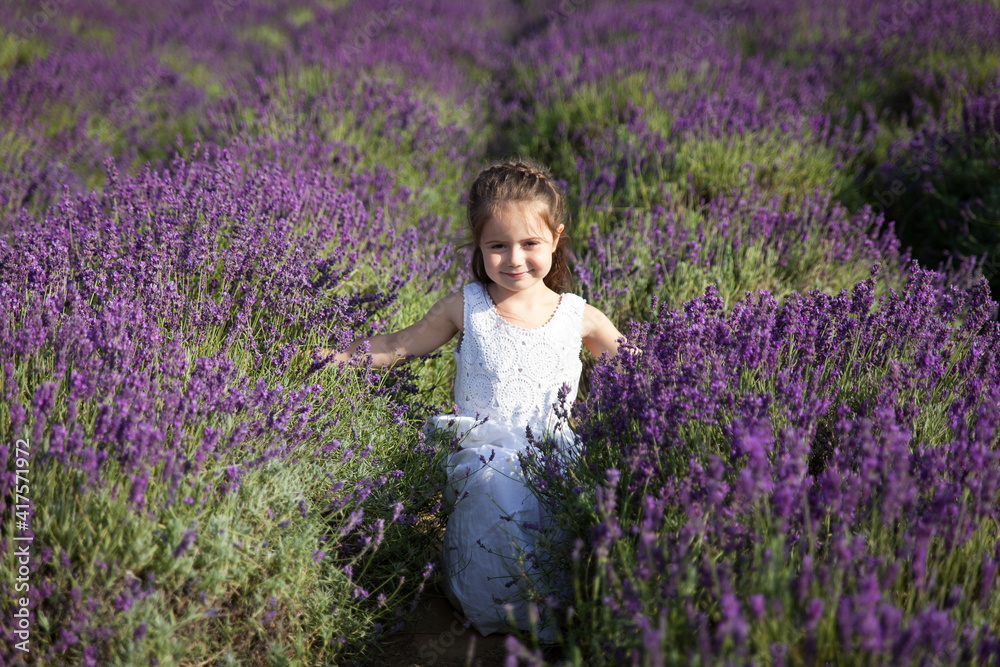 Cute little girl having fun in a lavender field Cute little girl having fun in a lavender field