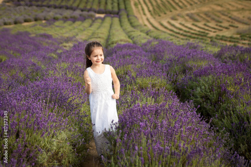 Cute little girl having fun in a lavender field © Olga Gorchichko