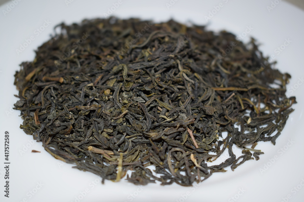 Fototapeta premium Green, black, herbal tea on a white background.