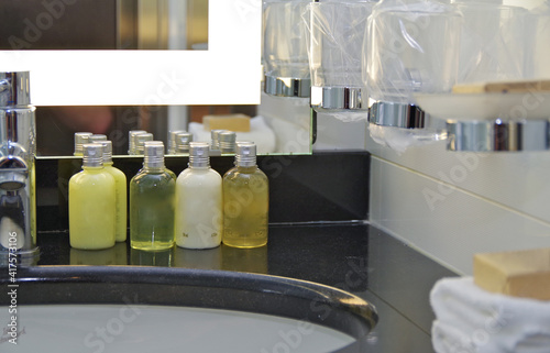 Foto Clean and modern design bathroom with sink, toiletries, care products and parts