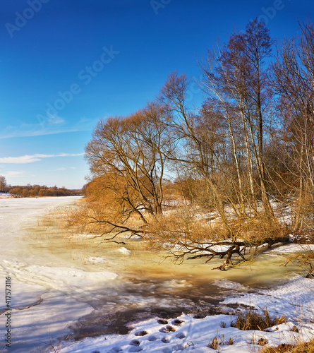 Obraz na płótnie Early Spring With Melting Ice And Snow. Nature in March. Lake and forest rural scene w salonie