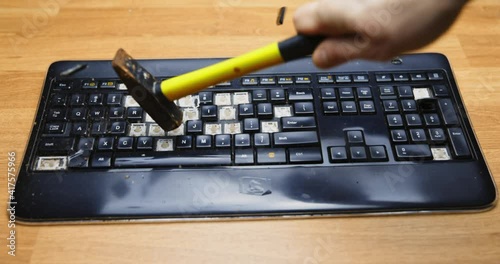 Shattering keyboard with hammer slow motion footage photo