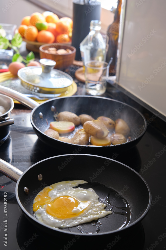 preparing fried eggs in a frying pan preparing fried eggs in a frying pan