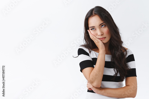 Girl cant stand long talks, wanna escape from boring meeting. Annoyed and bored fed up asian female, facepalm and roll eyes bothered, standing uninterested and dissatisfied over white background photo